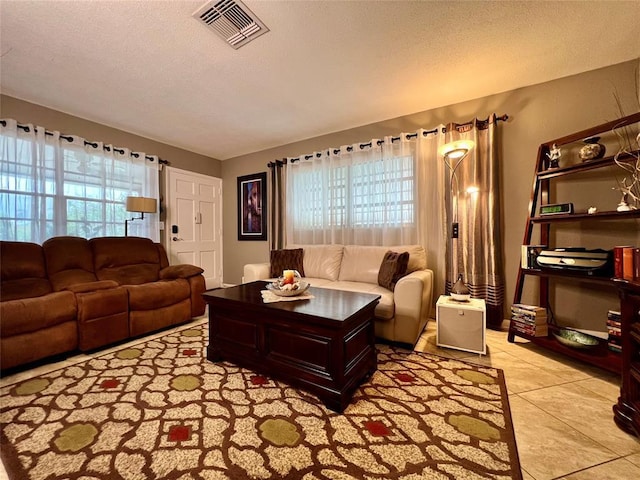 tiled living room with a textured ceiling