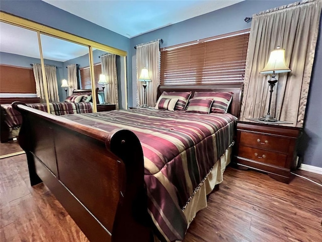 bedroom with a closet and dark hardwood / wood-style floors