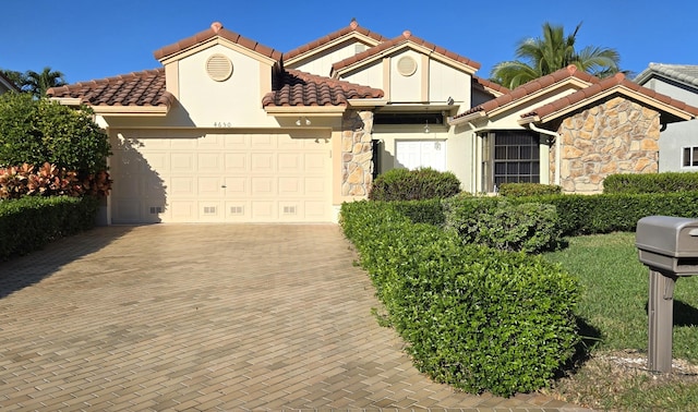 mediterranean / spanish home featuring a garage