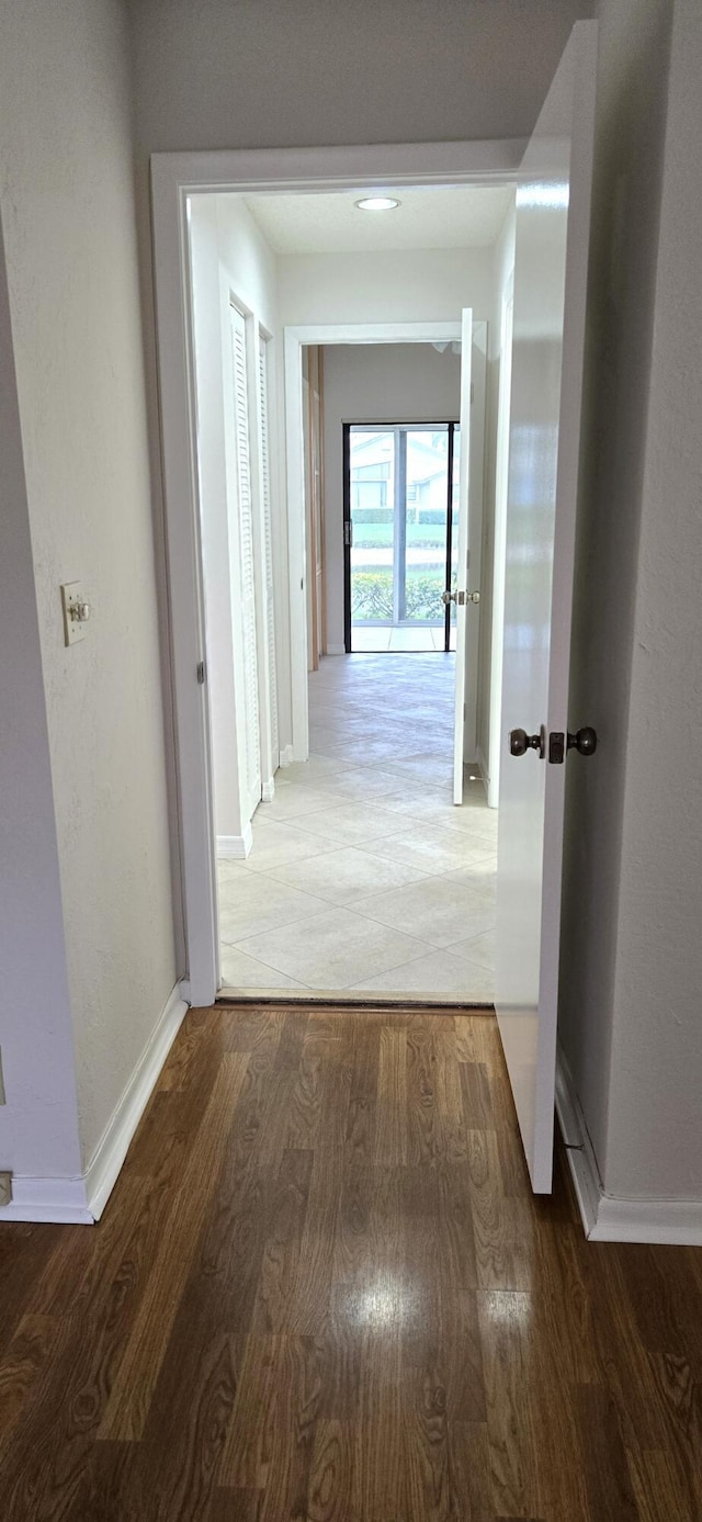 corridor with hardwood / wood-style floors