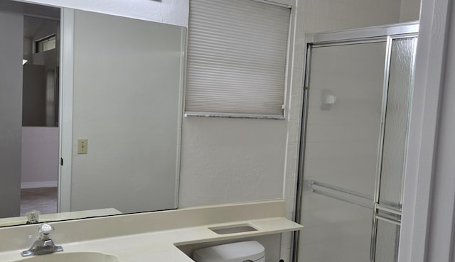 bathroom with vanity, toilet, and walk in shower