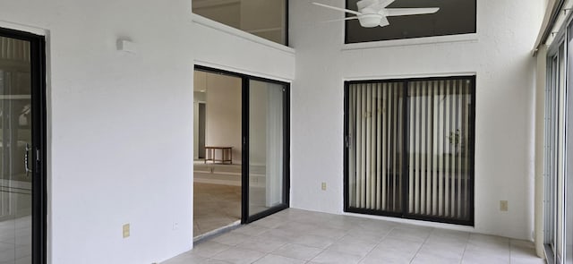 unfurnished sunroom featuring french doors and ceiling fan