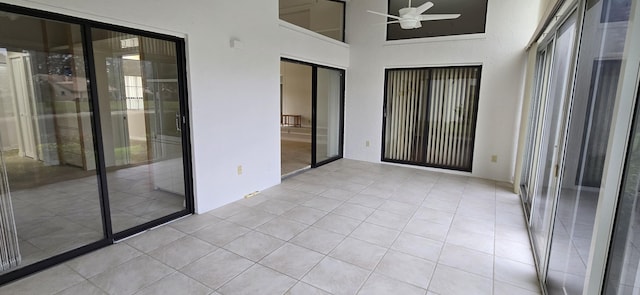 unfurnished sunroom featuring ceiling fan