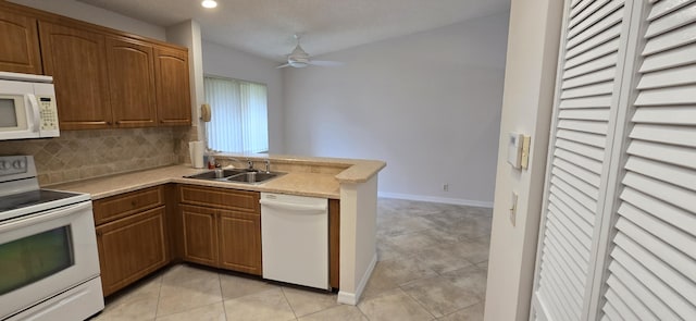 kitchen with sink, white appliances, light tile patterned floors, ceiling fan, and backsplash