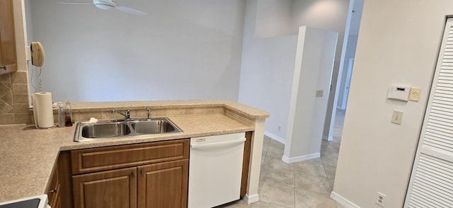 kitchen featuring light tile patterned flooring, sink, white dishwasher, ceiling fan, and stove