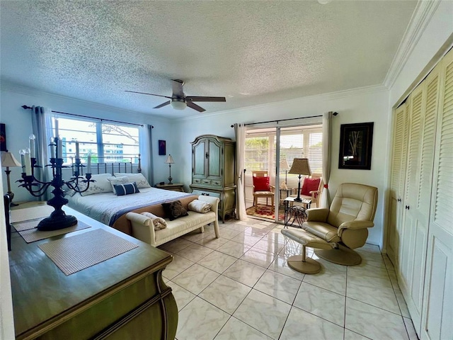 bedroom featuring ceiling fan, a closet, a textured ceiling, and ornamental molding