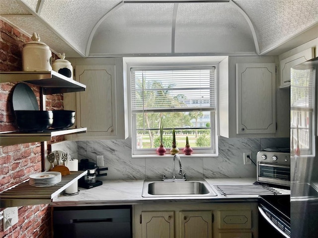 kitchen with tasteful backsplash, sink, dishwasher, range, and fridge