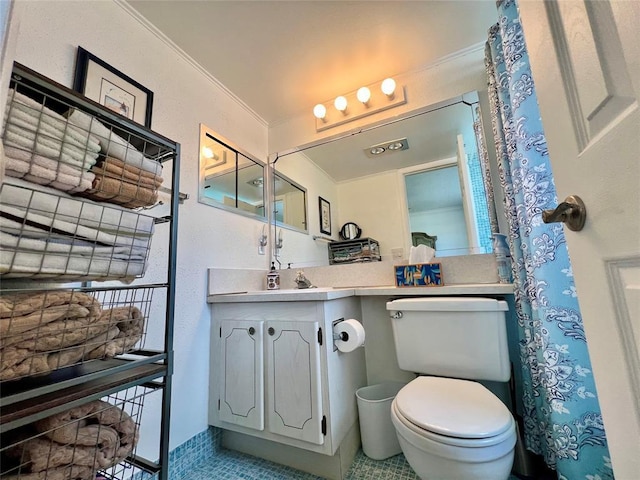 bathroom featuring tile patterned flooring, vanity, toilet, and crown molding