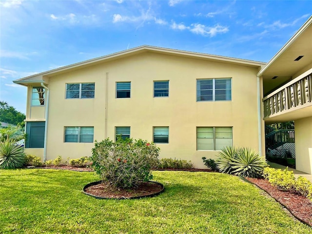 view of side of property with a yard