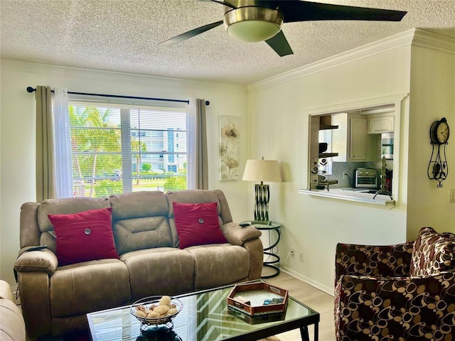 living room featuring crown molding, ceiling fan, a textured ceiling, and hardwood / wood-style flooring