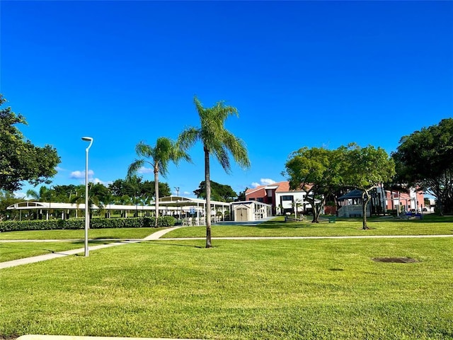 view of property's community with a lawn