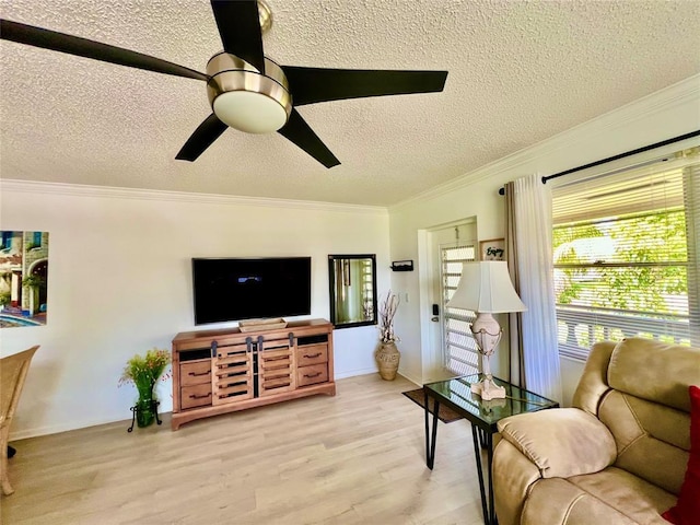 living room featuring a textured ceiling, light hardwood / wood-style floors, ceiling fan, and crown molding