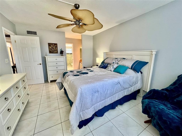 bedroom with ensuite bath and ceiling fan