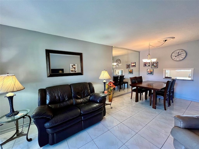 living room featuring light tile patterned floors and an inviting chandelier