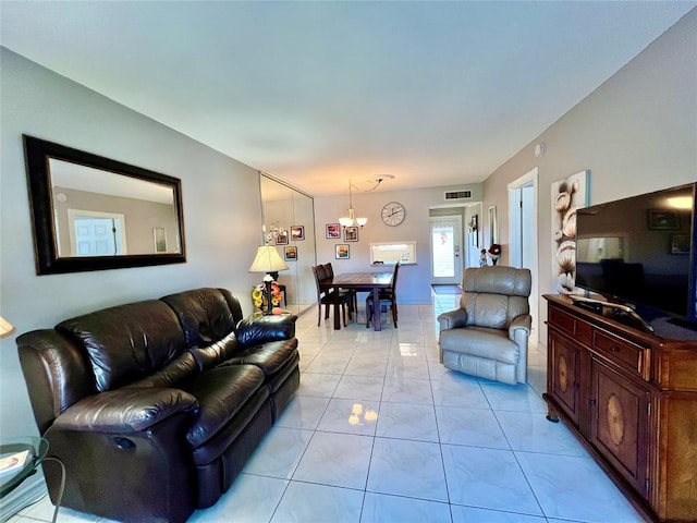 living room featuring a chandelier and light tile patterned floors