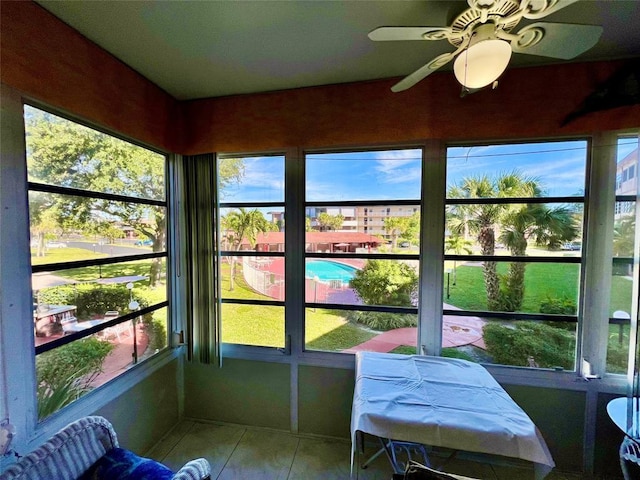 sunroom / solarium featuring ceiling fan