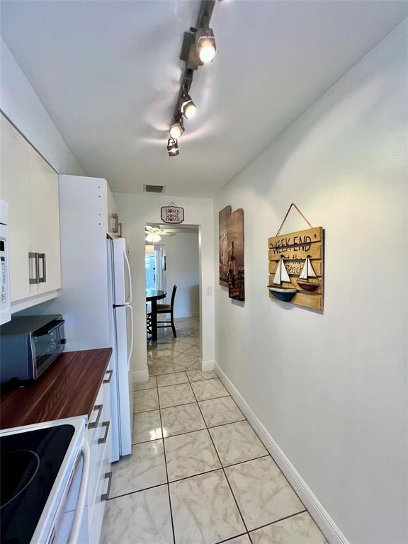 bedroom with ceiling fan and light tile patterned flooring