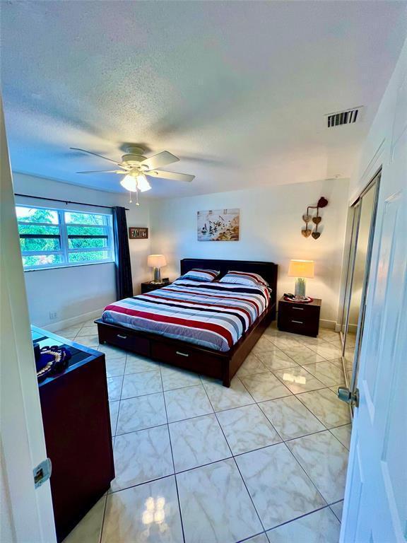 bedroom featuring light tile patterned floors and a closet