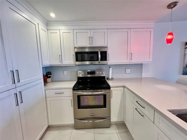 kitchen with white cabinets, decorative light fixtures, backsplash, and stainless steel appliances