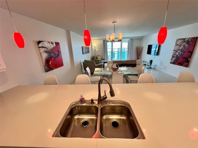 kitchen featuring sink, hanging light fixtures, and a chandelier