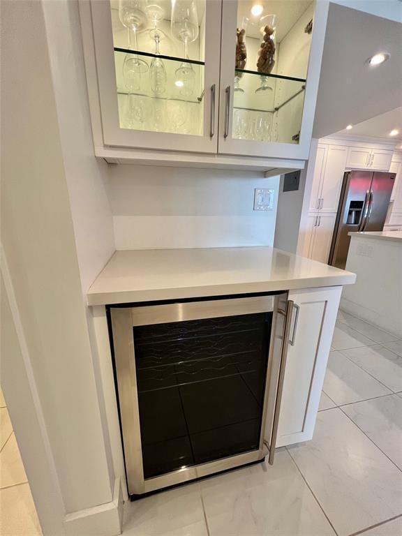 interior details with bar, stainless steel fridge, and wine cooler