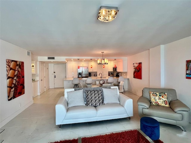 tiled living room featuring a chandelier