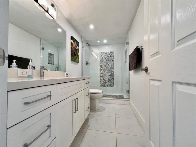 bathroom featuring vanity, toilet, and a shower with door