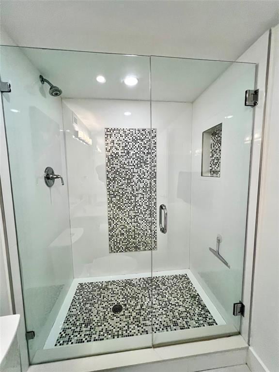 bathroom with tile patterned flooring and walk in shower