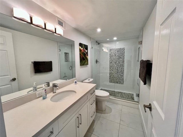 bathroom featuring vanity, toilet, and a shower with shower door