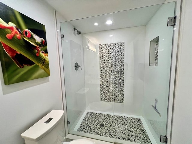 bathroom featuring toilet and an enclosed shower