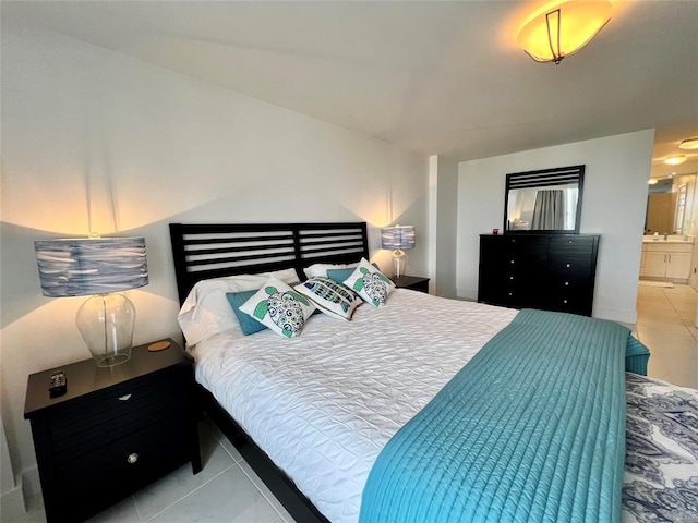 bedroom featuring light tile patterned floors and ensuite bath