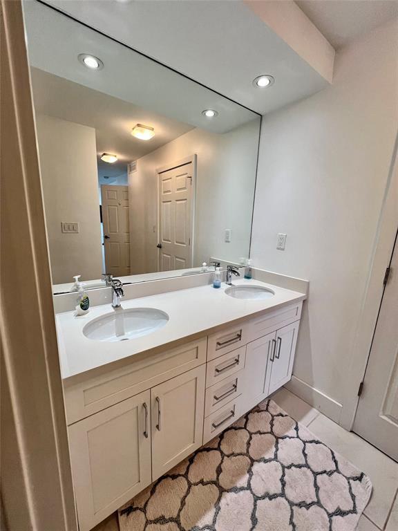 bathroom featuring tile patterned flooring and vanity