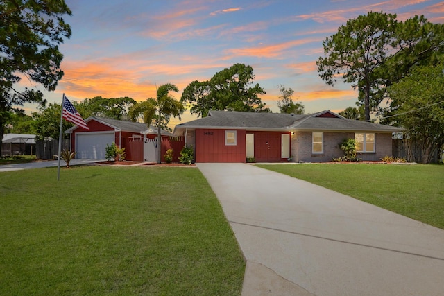 single story home with a lawn and a garage