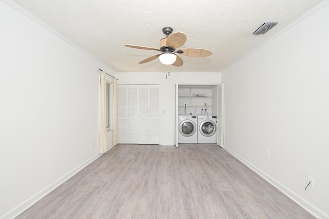 laundry area with washer and dryer, ceiling fan, light wood-type flooring, a textured ceiling, and ornamental molding