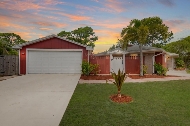 view of front of house featuring a garage and a lawn