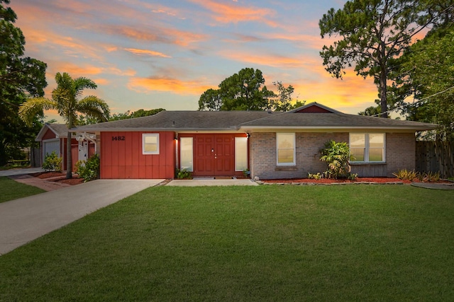 ranch-style home with a yard and a garage