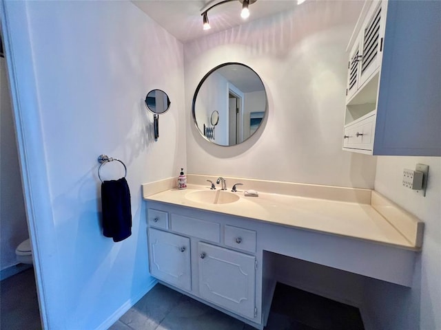 bathroom featuring tile patterned flooring, vanity, and toilet