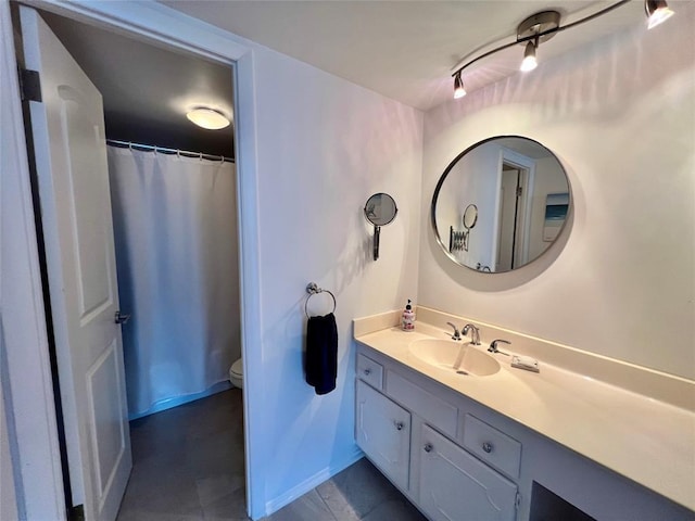 bathroom featuring vanity and toilet