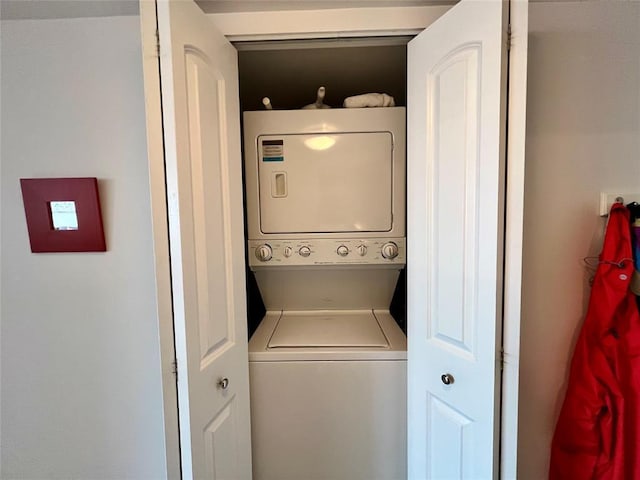 clothes washing area with stacked washer / drying machine