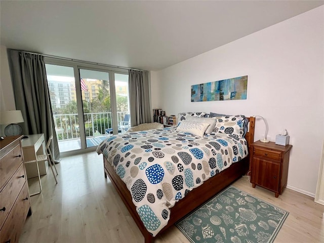 bedroom featuring access to outside and light hardwood / wood-style flooring