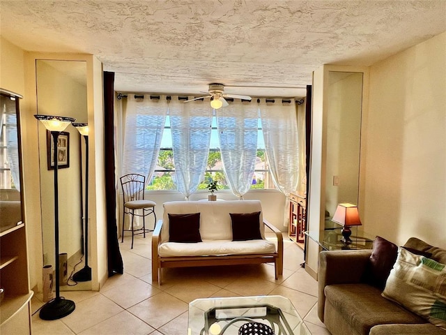 sitting room with ceiling fan and light tile patterned flooring