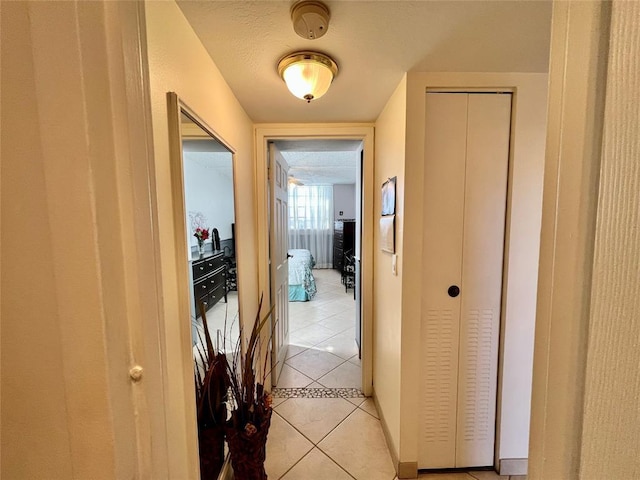 hall featuring light tile patterned floors