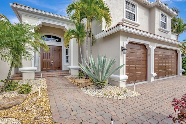 doorway to property with a garage