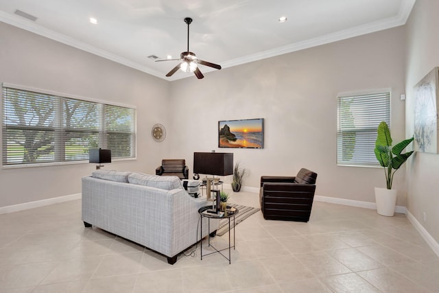 tiled living room with ceiling fan and crown molding