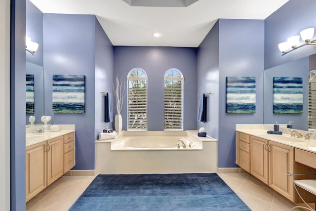 bathroom featuring a bathing tub, tile patterned flooring, and vanity