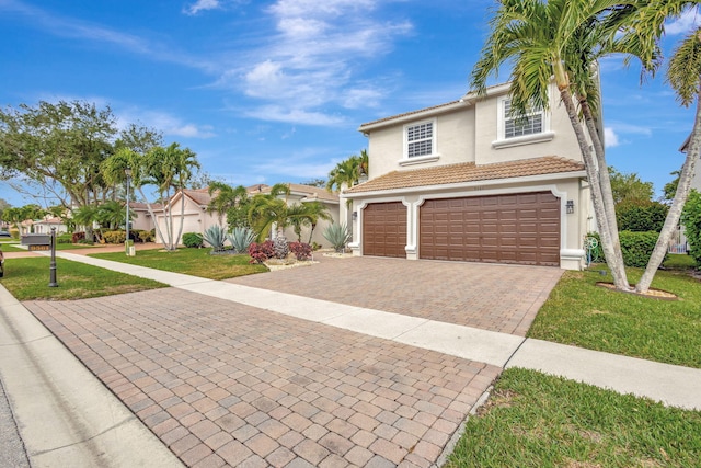 view of front of house with a garage and a front lawn