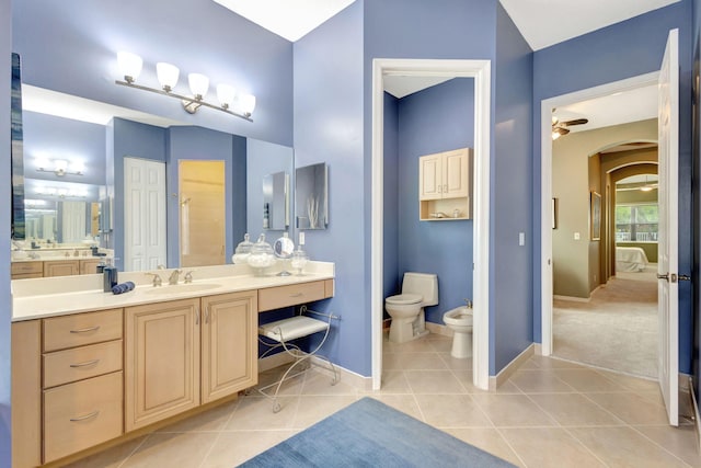 bathroom featuring ceiling fan, vanity, tile patterned flooring, toilet, and a bidet