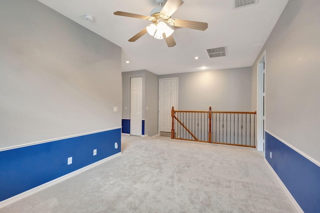 carpeted empty room with ceiling fan