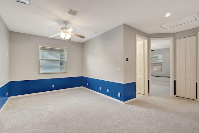 unfurnished room with ceiling fan and light carpet