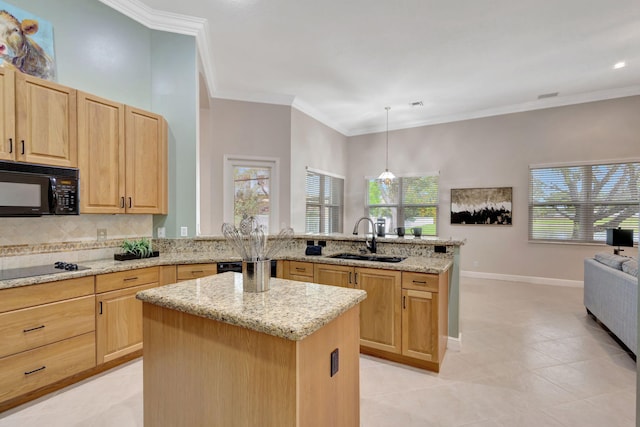 kitchen with black appliances, kitchen peninsula, sink, and a kitchen island